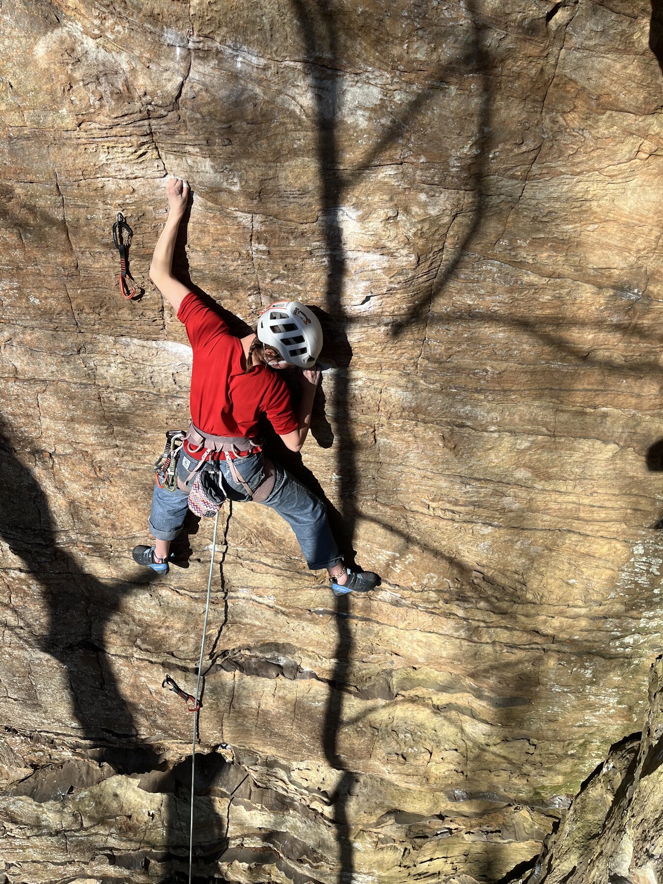 Sport Climbing - Pendergrass-Murray Recreational Preserve Climber in a helmet reaching for a hold on a sport route at Pendergrass-Murray Recreational Preserve, Red River Gorge